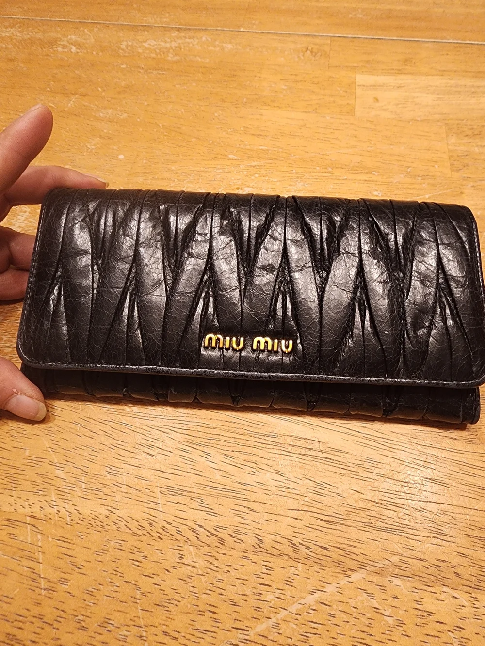 black quilted leather Miu Miu Matelassé long bifold wallet gold-tone Logo